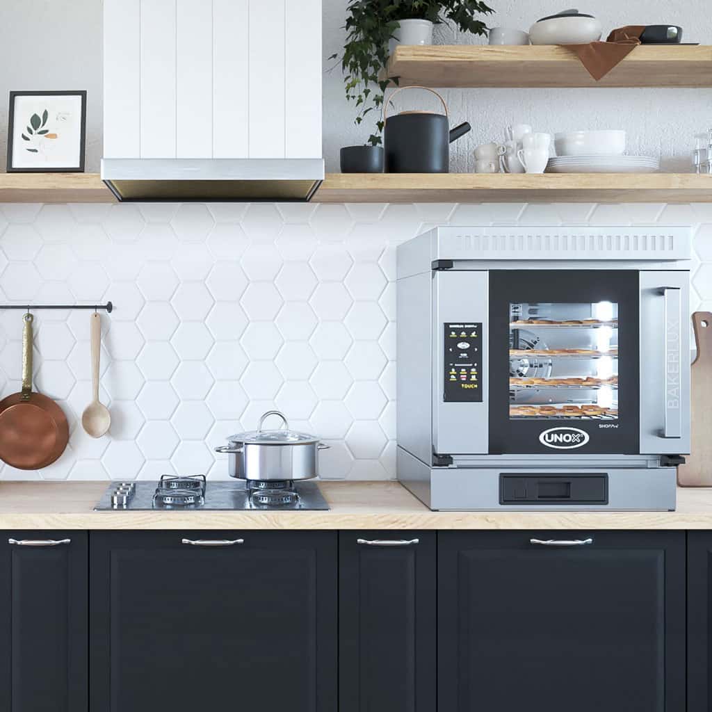 Home kitchen with an Unox bakerlux oven sat on the countertop, pastries baking in the oven.