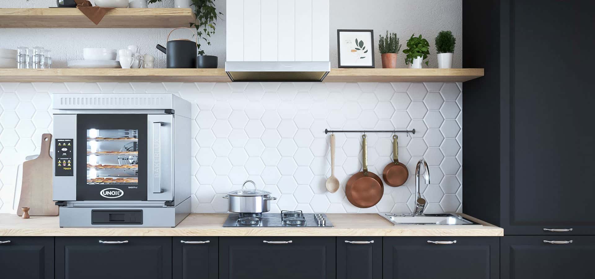 Home kitchen with an Unox bakerlux oven sat on the countertop, pastries baking in the oven.