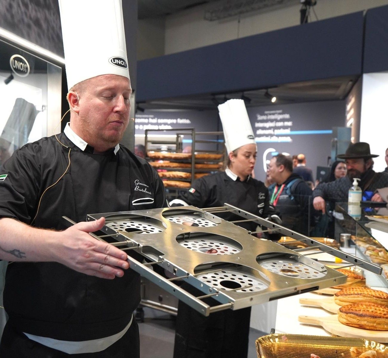 Chef displaying a commercial panettone tray used in Unox combi ovens