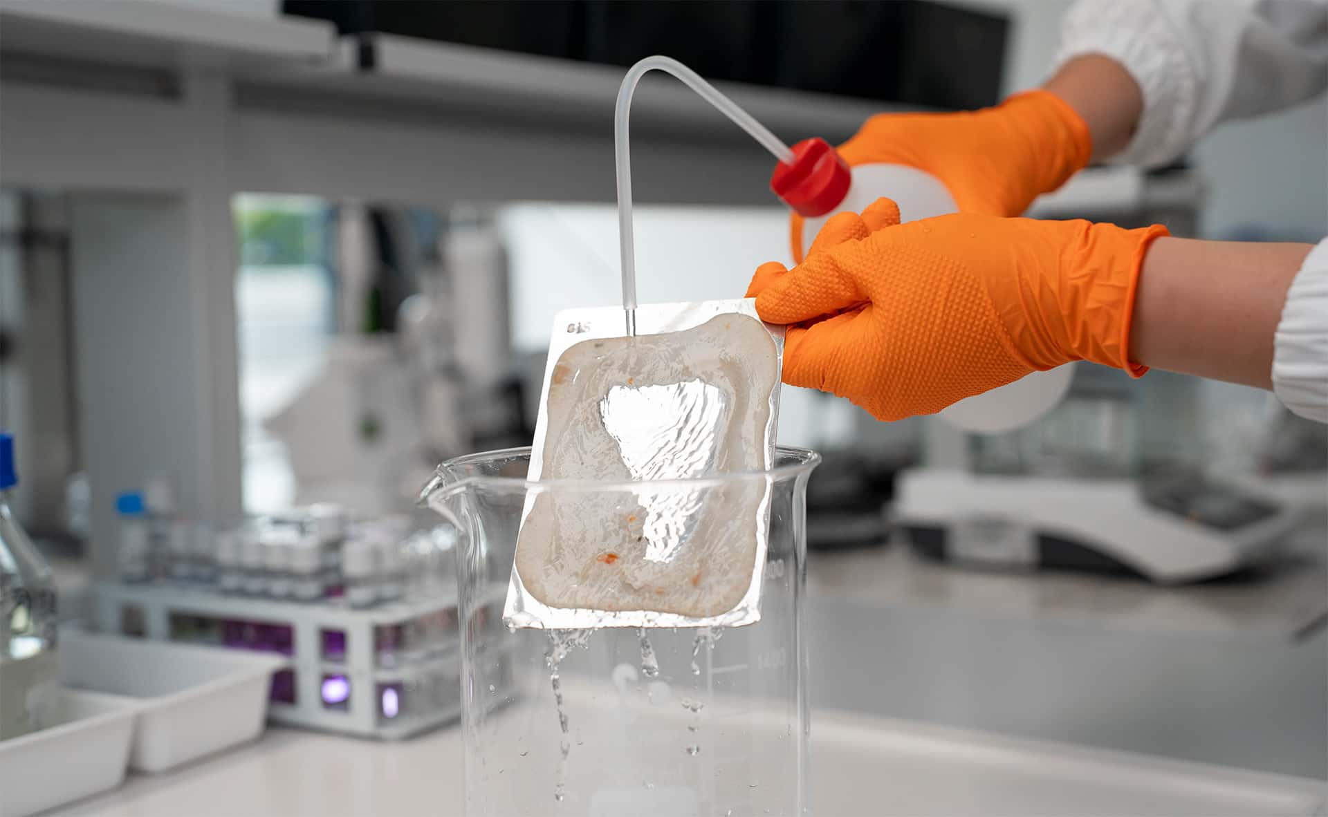 chemist performing a cleaning efficiency test on a soiled sample