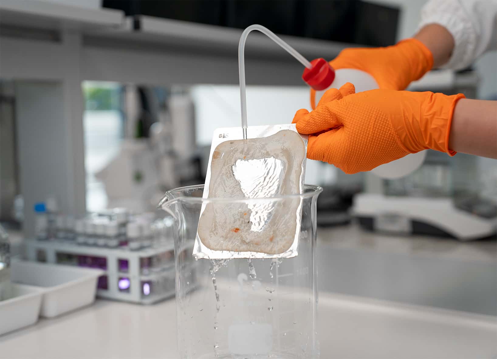 chemist performing a cleaning efficiency test on a soiled sample