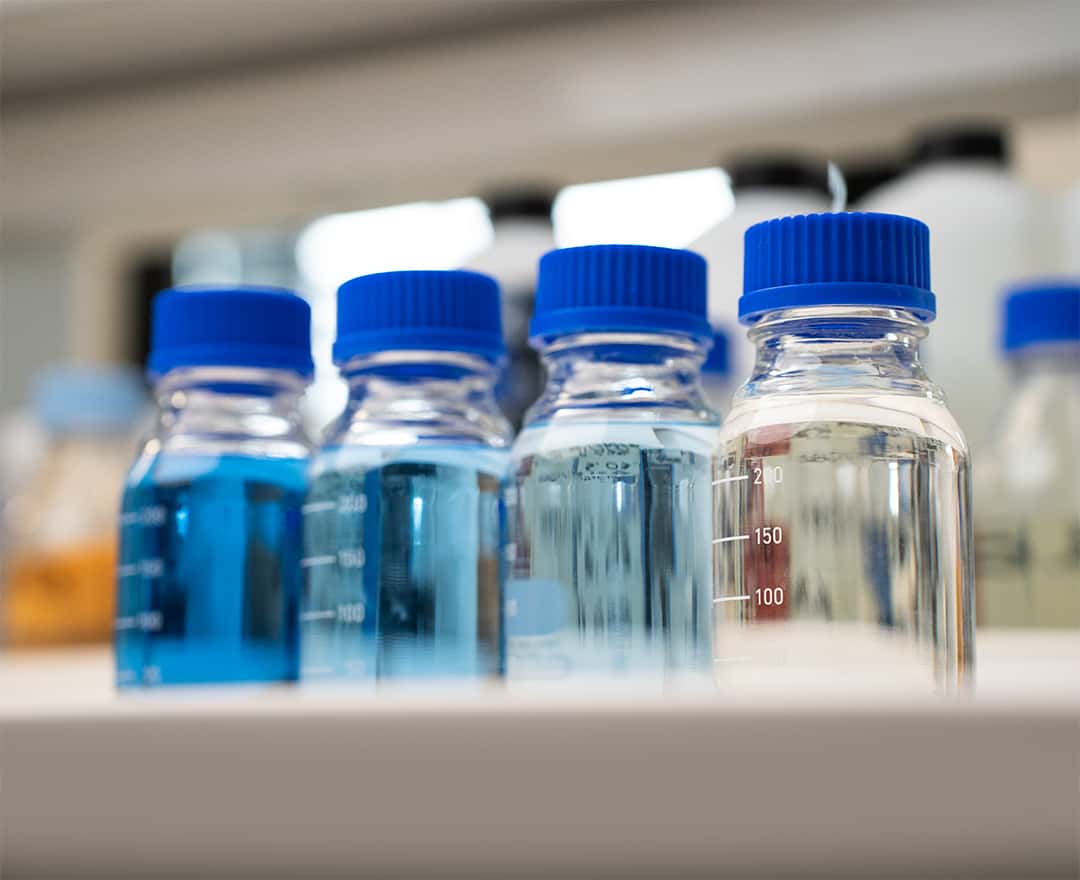 graduated glass bottles with prototype detergents for commercial oven cleaning