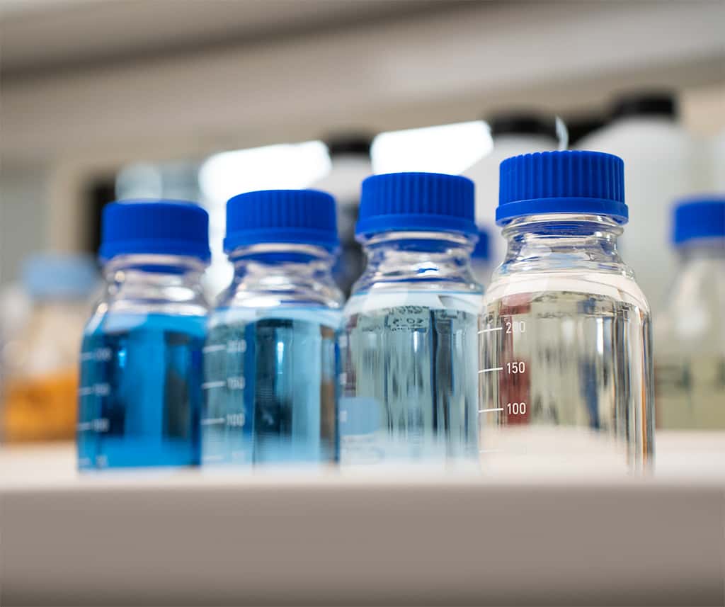 graduated glass bottles with prototype detergents for commercial oven cleaning