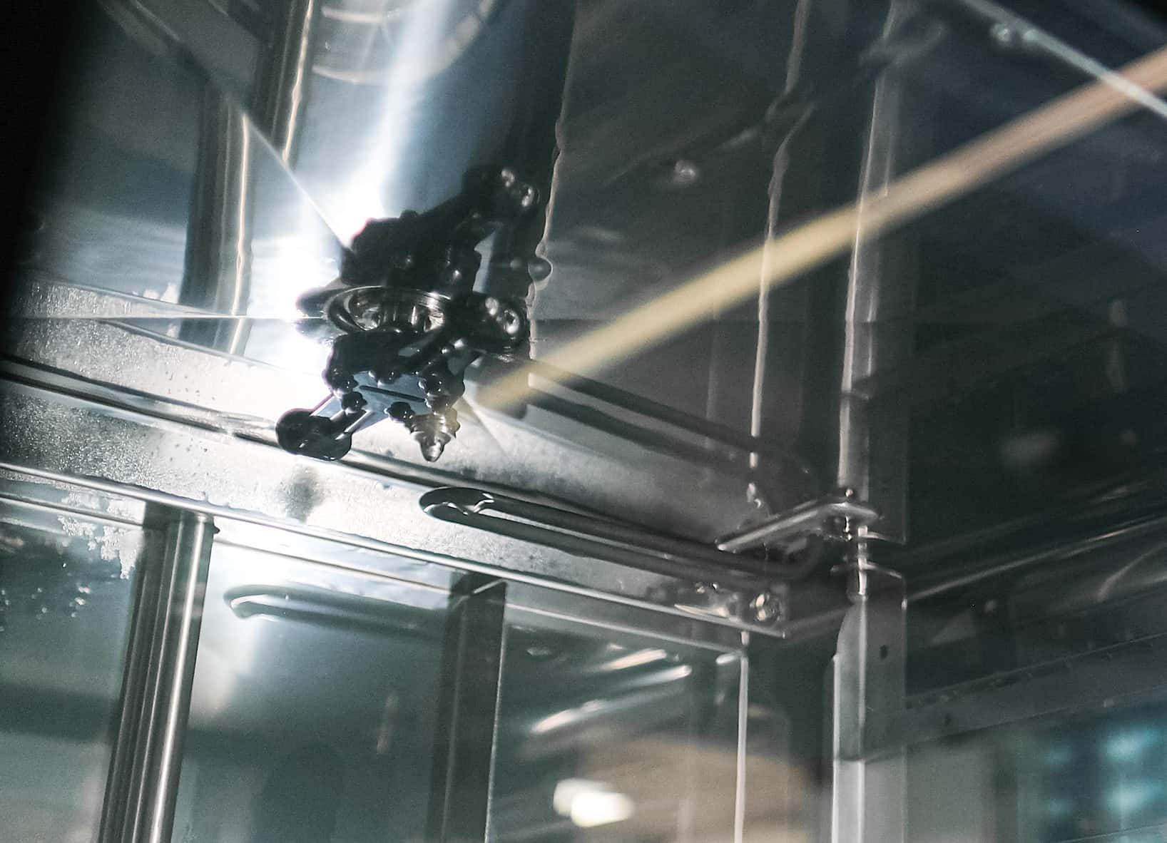 rotating spray arm of a professional oven washing system in action