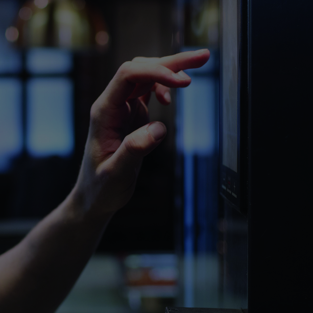 Close-up of a hand touching a digital panel.